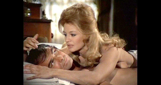 Burt Reynolds as Sam Whiskey being convinced by Angie Dickinson as Laura Breckenridge in Sam Whiskey (1969)