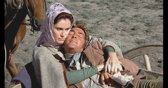 Dean Martin as Bill Massey, pretending to be passed out, gets close to Kate in Showdown (1973)