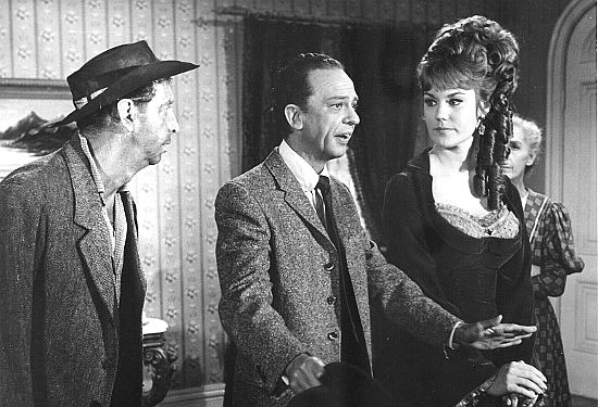 Don Knotts as Dr. Jesse Heywood wonders about the wisdom of getting married without his mother in attendance. Future bride Penelope Cushings (Barbara Rhoades) looks on  in The Shakiest Gun in the West (1969)