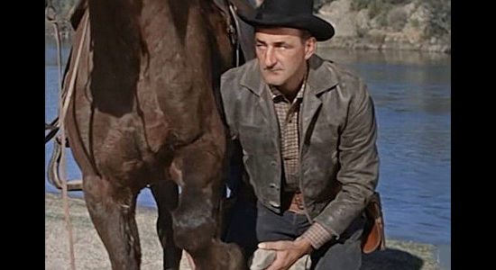 Jack Carr as A.J. Beaumont, a wanted man sensing someone is following him in The Purple Hills (1961)