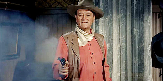 John Wayne as Cole Thorton, putting his six-gun to good use on Jason's men in El Dorado (1967)