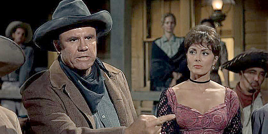 R.G. Armstrong as Kevin MacDonald, Jason's rival rancher as Maudie (Charlene Holt) looks on in El Dorado (1967)