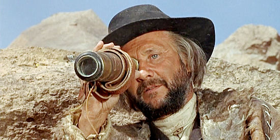 Donald Pleasance as Preacher Quint, spying on Will Penny with revenge on his mind in Will Penny (1967)