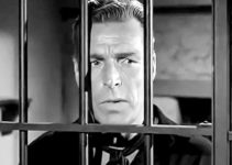 Buster Crabbe as Kip Tanner finds himself on the wrong side of the jail bars in Gunfighters of Abilene (1960)