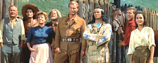 From left, Patterson, Uncle Gunstick, Mrs. Butler, Sam Hawkens, Old Shatterhand, Winnetou, Fred Engel and Ellen Patterson watch the Indians ride off after a heroic charge in Treasure of Silver Lake (1962)