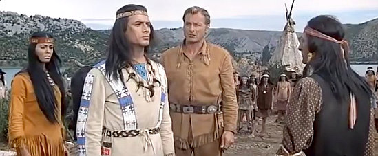 Pierre Brice as Winnetou contemplates war or peace as Daliah Lavi as The White Dove and Lex Barker as Old Shatterhand look on in Apache's Last Battle (1964)