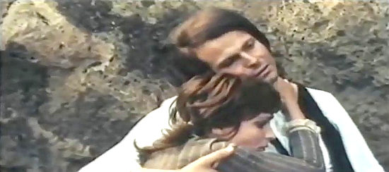 Susanna Levi as Suzy Barton and her fiance (Franco Borelli) embrace after escaping an ambush in Death Played the Flute (1972)