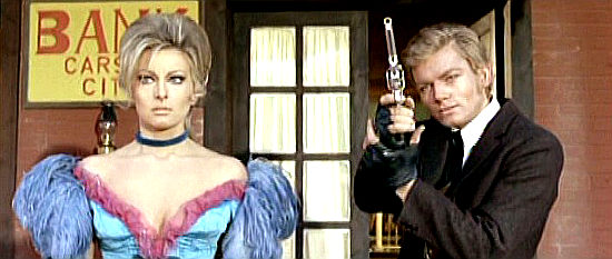 Peter Lee Lawrence as Silver takes aim at another payday while Dolly (Helene Chanel) watches in Killer Caliber .32 (1967)