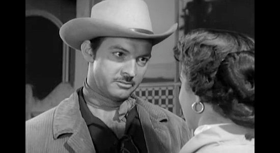 Zachary Scott as Ross Haney, about to show Sherry Vernon how she can pay a debt in Treasure of Ruby Hills (1955)