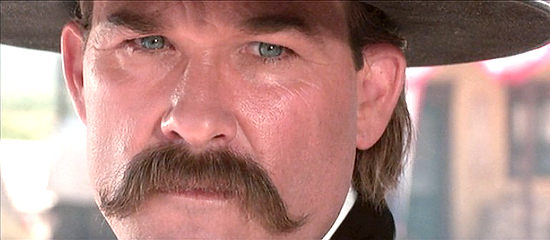 Kurt Russell as Wyatt Earp, sensing trouble's about to start at the OK Corral in Tombstone (1993)