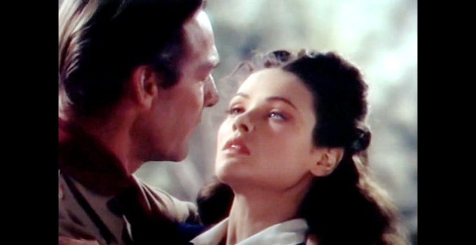 Gene Tierney as Belle Starr, in the arms of Sam Starr (Randolph Scott) in Belle Starr (1941)