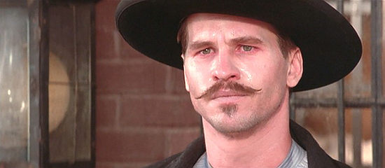 Val Kilmer as Doc Holliday, who counts Wyatt among his few friends in Tombstone (1993)