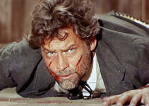 Carl Mohner as Larry Kitchener, beaten and bloodied by Reyes’ men in The Man Who Came to Kill (1965)
