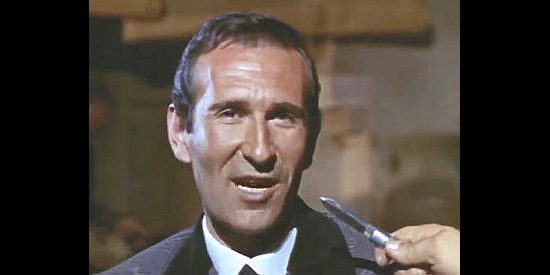Umberto Raho as Brogan, mayor of Baldosas, finding himself at the point of Reyes' knife in The Man Who Came to Kill (1965)