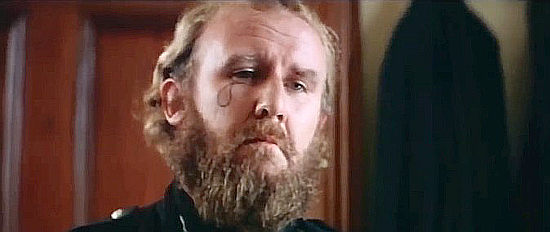 Bill Hunter as Sergeant Smith, the man who brands Daniel in Mad Dog Morgan (1975)