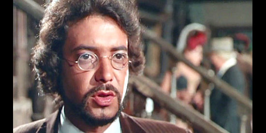 Carlos Romero Marchent as Lou Stafford, suspecting Danny is the one leaving wanted posters around Black Point in Prey of the Vultures (1972)