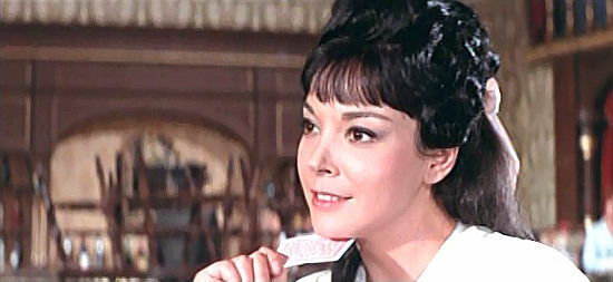 Elisa Montes as Sybil, a saloon singer day dreaming about a handsome young man named Jerry in Seven Dollars on the Red (1966)