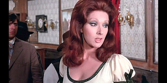 Helga Line as Maybelle, the saloon owner who looks to Grayson for protection in Raise Your Hands Dead Man, You're Under Arrest (1971)