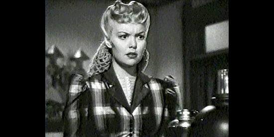 Jane Wyman as Mary Hathaway questions Merrick's plan to foreclose on mortgages in Bad Men of Missouri (1941)