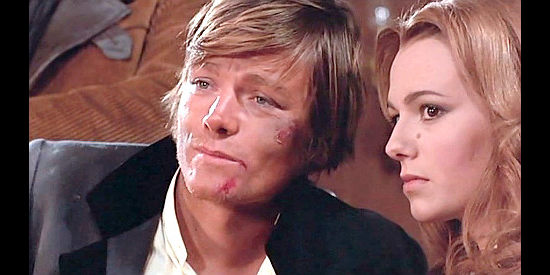 Peter Lee Lawrence as Kid Johnson with girlfriend Nora Carson (Maria Zanandrea) after a beating in Raise Your Hands Dead Man, You're Under Arrest (1971)