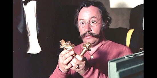 Philippe Noiret as Gen. Terry, admiring the golden railroad spikes he receives as a bride to annihilate the Indians in Don't Touch the White Woman (1974)