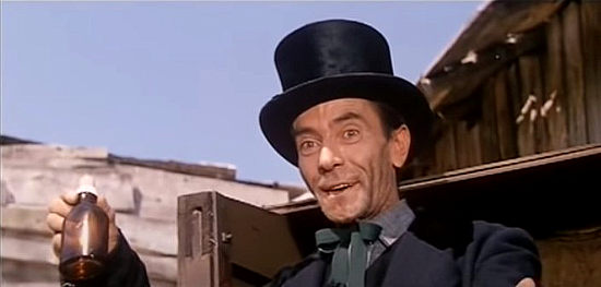 Ralph Webb as Alan, Lara's brother, selling his magic elixir in Long Day of the Massacre (1968)