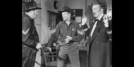 Bill Elliott as Jim McWade, about to bust Barker out of jail while Gibson Hart (Albert Dekker, right) looks on in The Fabulous Texan (1947)