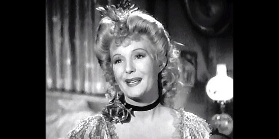 Binnie Barnes as Lacey Miller, twisting Brit Dawson around her finger again in In Old California (1942)