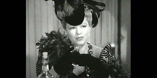 Claire Trevor as Gold Dust Nelson, filling Lucy in on the real Candy Johnson in Honky Tonk (1941)