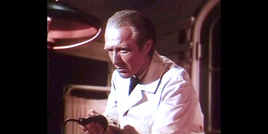 Grandon Rhodes as Dr. Mason, providing Tom Andrews with a transfusion, with Dr. Edith Cabot's help, in Canadian Pacific (1949)