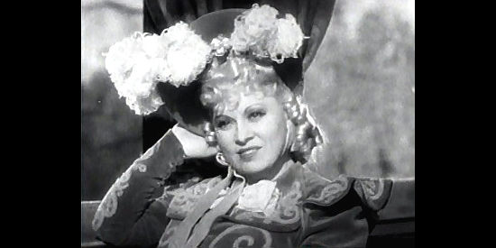 Mae West as Flower Belle Lee, sensing a new opportunity aboard a westbound train in My Little Chickadee (1940)