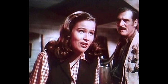 Nancy Olson as Cecille Gautier, talking on the railroad's behalf as her father (John Parrish) looks on in Canadian Pacific (1949)