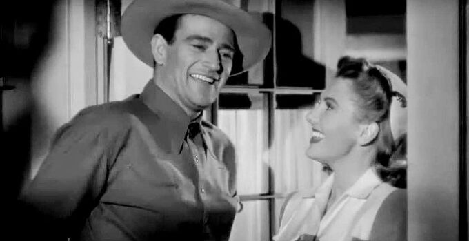 John Wayne as Duke Hudkins and Jean Arthur as Molly J. Truesdale in Lady Takes a Chance (1943)