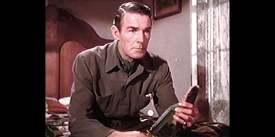 Randolph Scott as Chris Denning, with the knife his fiance used to kill herself in Coroner Creek (1948)