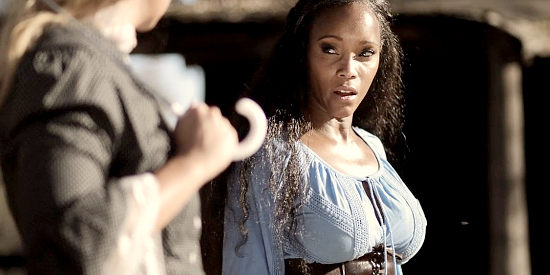Alanna Forte as Hannah, the slave girl taken to a deserted town by the woman she serves in From Hell to the Wild West (2017).