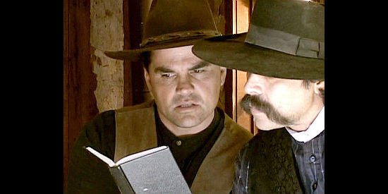 Angelo Ortega as Sheriff Tom Peavy and Deputy Conley (Miguel Corona) look for clues in the school teacher's diary in Sheriff of Contention (2010)