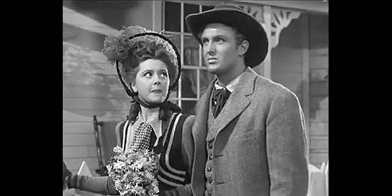 Ann Rutherford as Anne Grayson and Robert Stack as Jim Holliday try to break their surprising news in Badlands of Dakota (1941)