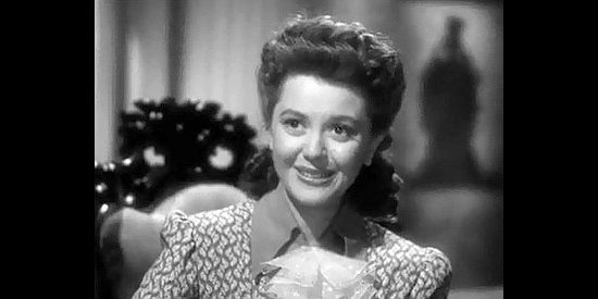 Ann Rutherford as Anne Grayson, looking forward to adventures out West in Badlands of Dakota (1941)