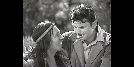 Charles Stevens as Crying Loon, the crazy Indian, with John Carroll as Pierre in Pierre of the Plains (1942)
