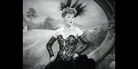 Claire Trevor as Dora Hand, the saloon girl who turns the head of Bat Masterson and King Kennedy in The Woman of the Town (1943)