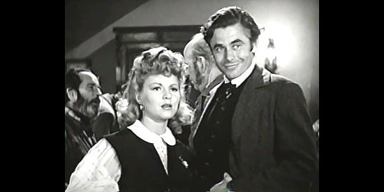 Claire Trevor as Mike King, pointing out the man who hijacked her buckboard to Tod Ramsey (Glenn Ford) in Texas (1941)