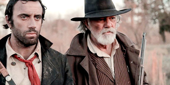 Daniel Van Thomas as The Preacher and Daniel Britt as Marshal Edwards, preparing for an undead onslaught in Revelation Trail (2013)