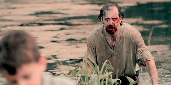 Donald R. Fleming as Jakob Bannon rises from the water as a member of the undead in Revelation Trail (2013)