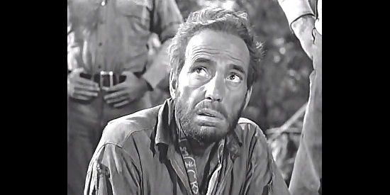 Humphrey Bogart as Fred C. Hobbs, suspicious of a stranger in The Treasure of the Sierra Madre (1948)