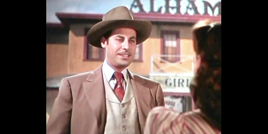 John Hodiak as Ned Trent, the man who capitalizes off drinking, gambling and women in The Harvey Girls (1946)