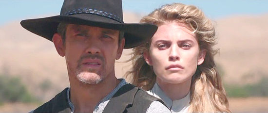 Neal Bledsoe as Frank Conner and AnnaLynne McCord as Heather, riding back into trouble, in A Soldier's Revenge (2020)