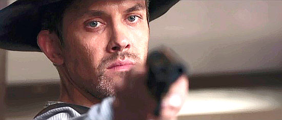 Neal Bledsoe as Frank Conner, with an enemy under his gun in A Soldier's Revenge (2020)