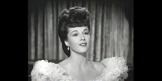 Patricia Dane as Jean Avery, entertaining guests of The Topaz with a song in Northwest Rangers (1942)