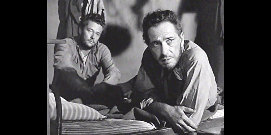 Tim Holt as Bob Curtin and Humphrey Bogart as Dobbs, intrigued by Howard's talking of gold mining in The Treasure of the Sierra Madre (1948)
