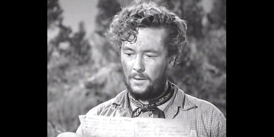 Tim Holt as Bob Curtin reads a letter written by a dead man's wife in The Treasure of the Sierra Madre (1948)